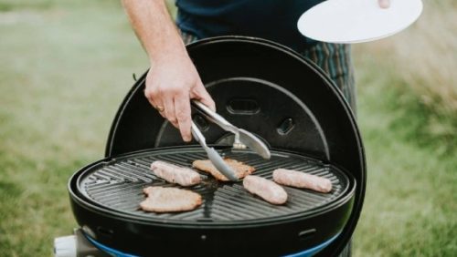 How to Clean an Electric Grill: The Complete Guide 1 man cooking burgers and hotdogs on bbq grill